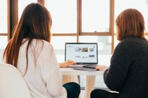 Two women in front of computer